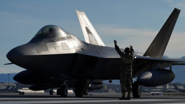 U.S. Air Force Staff Sgt. Christopher Graham, 3rd Wing crew chief, marshalls an F-22 Raptor on the flight line at Joint Base Elmendorf-Richardson, Alaska, during an elephant walk, May 5, 2020. The large show-of-force demonstrated the wings’ rapid mobility capabilities and response readiness during COVID-19 and also highlighted the ability to generate combat airpower at a moment’s notice to ensure regional stability throughout the North American Aerospace Defense Command Region and Indo-Pacific. (U.S. Air Force photo by Tech. Sgt. Westin Warburton)