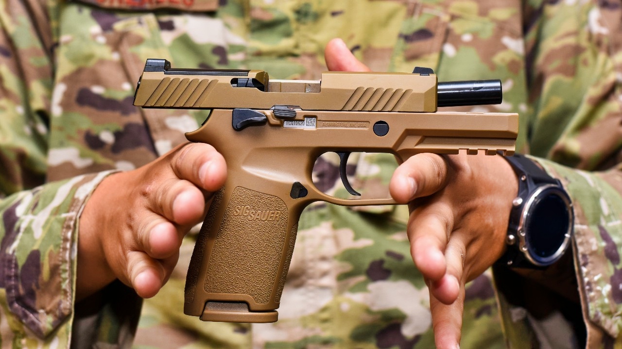 Staff Sgt. Will Gonzales, 36th Security Forces Squadron armory NCO in charge, displays a Sig Sauer M18 pistol on Andersen Air Force Base, Guam, Aug. 26, 2019. The M18 provides improved trigger pull, tritium night sights, larger ammo capacity, weapon reliability and durability to strengthen shooter lethality. (U.S. Air Force photo by Airman 1st Class Michael S. Murphy)