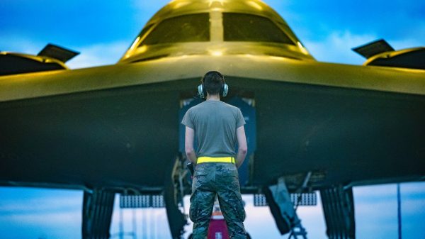 A U.S. Air Force Airman assigned to the 509th Maintenance Group prepares to marshal a B-2 Spirit stealth bomber to take off in support of a Bomber Task Force deployment to Australia at Whiteman Air Force Base, Mo., Aug. 15, 2024. Bomber missions familiarize aircrew with air bases and operations in different Geographic Combatant Commands areas of operations. (U.S. Air Force photo by Airman 1st Class Bryce Moore)