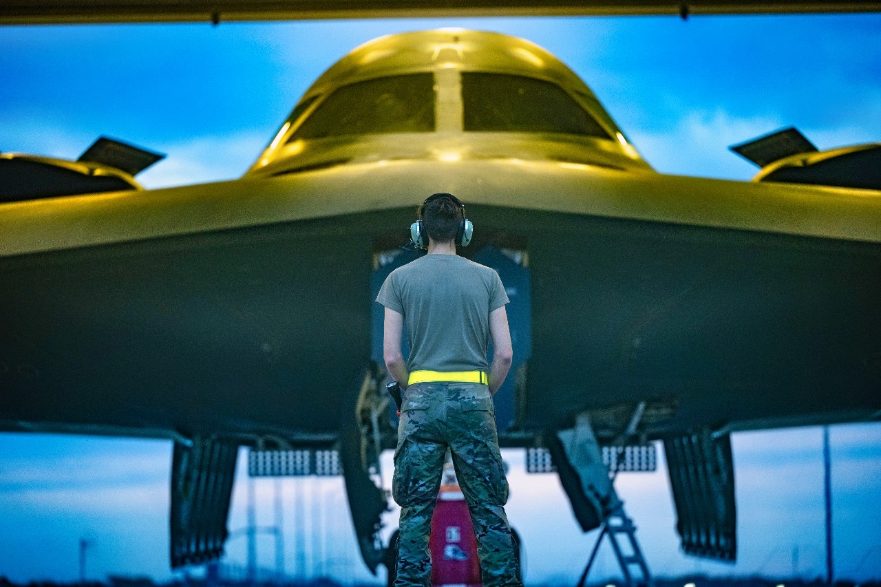 A U.S. Air Force Airman assigned to the 509th Maintenance Group prepares to marshal a B-2 Spirit stealth bomber to take off in support of a Bomber Task Force deployment to Australia at Whiteman Air Force Base, Mo., Aug. 15, 2024. Bomber missions familiarize aircrew with air bases and operations in different Geographic Combatant Commands areas of operations. (U.S. Air Force photo by Airman 1st Class Bryce Moore)