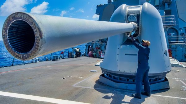 (Aug. 22, 2023) Gunner's Mate 2nd Class Chase Allen maintains the barrel of a Mark 45 5-inch light-weight gun on the fo’c'sle of the Arleigh Burke-class guided-missile destroyer USS Paul Hamilton (DDG 60) in the Pacific Ocean, Aug. 22, 2023. Paul Hamilton is deployed to the U.S. 3rd Fleet area of operations. (U.S. Navy photo by Mass Communication Specialist 2nd Class Elliot Schaudt)
