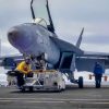 ATLANTIC OCEAN (Aug. 13, 2025) Sailors transport an F/A-18E Super Hornet attached to the "Gladiators" of Strike Fighter Squadron (VFA) 106 onto an aircraft elevator aboard the Nimitz-class aircraft carrier USS George H.W. Bush (CVN 77). George H.W. Bush is underway conducting carrier qualifications and routine operations in the Atlantic Ocean. (U.S. Navy photo by Mass Communication Specialist Seaman Apprentice Kayleigh Tucker)