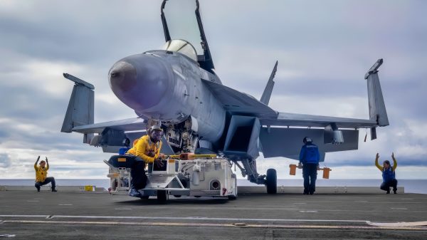 ATLANTIC OCEAN (Aug. 13, 2025) Sailors transport an F/A-18E Super Hornet attached to the "Gladiators" of Strike Fighter Squadron (VFA) 106 onto an aircraft elevator aboard the Nimitz-class aircraft carrier USS George H.W. Bush (CVN 77). George H.W. Bush is underway conducting carrier qualifications and routine operations in the Atlantic Ocean. (U.S. Navy photo by Mass Communication Specialist Seaman Apprentice Kayleigh Tucker)