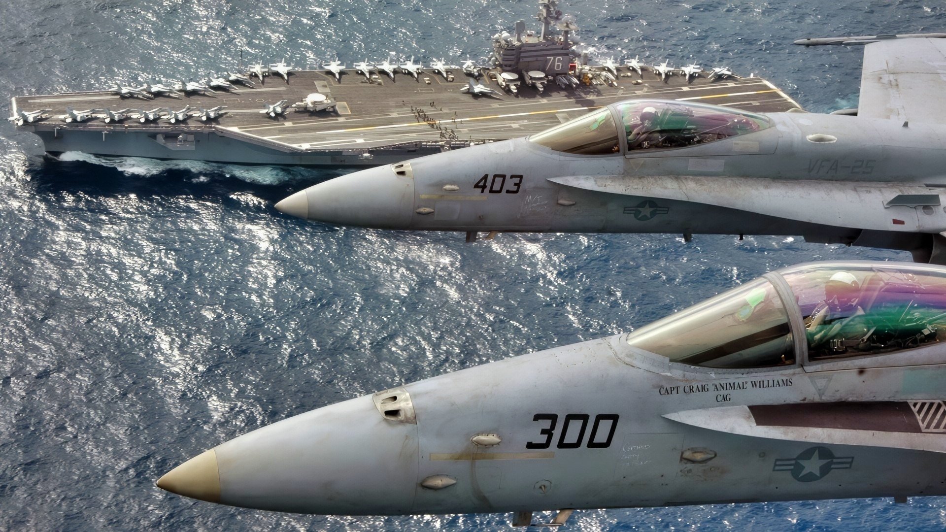 At sea (Mar. 1, 2007) – Capt. Craig “Animal” Williams (front) in a F/A 18C Hornet (front) and Capt. Richard “Rhett” Butler (back) in an F/A 18C Hornet look up for a photo as they fly over USS Ronald Reagan (CVN 76). Capt. Williams, a 22-year Naval Aviator who graduated from the United States Naval Academy, was relieved as Commander, Carrier Air Wing Fourteen (CVW-14) by 21-year Naval Aviator, Capt. Butler, a graduate of the University of Kentucky during an aerial change of command ceremony. The Ronald Reagan Carrier Strike Group is currently underway in the Pacific Ocean on a surge deployment in support of U.S. military operations in the Western Pacific. Official U.S. Navy photo by Lt. Cmdr. Tam Pham