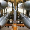 A front view of four nuclear free-fall bombs on a bomb cart. Image Credit: Creative Commons.