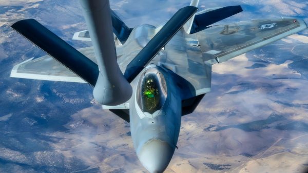 An F-22 Raptor approaches to receive fuel from a KC-135 Stratotanker assigned to the 92nd Air Refueling Wing during the Weapons Integration course over the Nevada Test and Training Range, Dec. 12, 2023. Air refueling crews assigned to the 92nd, 93rd and 97th Air Refueling Squadrons at Fairchild Air Force Base, Washington, participated in the WSINT course to enhance interoperability with a variety of aircraft and demonstrate how Air Mobility Command’s air refueling capabilities enhance global reach for all Department of Defense air operations. WSINT is a series of complex, large-force employment missions that serve as the capstone portion of Weapons School classes, which take place twice a year at Nellis Air Force Base, Nevada. WSINT students plan and execute every aspect of air, space and cyber combat operations, with joint force components converging over the Nevada Test and Training Range. (U.S. Air Force photo by Senior Airman Haiden Morris)