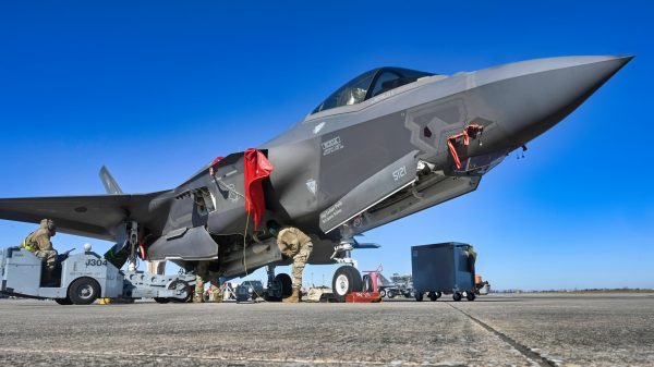 U.S. Air Force Airmen load a munition onto an F-35 Lightning II in preparation to conduct a scenario during Checkered Flag 24-1 at Tyndall Air Force Base, Florida, Nov. 1, 2023. Checkered Flag is a large-force aerial exercise held at Tyndall Air Force Base which fosters readiness and interoperability through the incorporation of 4th and 5th-generation aircraft during air-to-air combat training. (U.S. Air Force photo by Staff Sgt. Jake Carter)