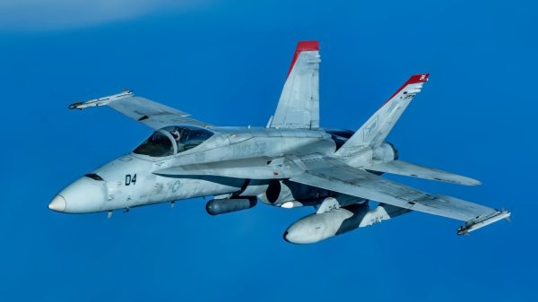 A U.S. Marine Corps F/A-18 Hornet pulls away from a U.S. Air Force KC-135 Stratotanker from Kadena Air Base after refueling over the Pacific Jan. 3, 2024. Conducting joint operations enhances the lethality and readiness of U.S. forces and its ability to project superior airpower to the Indo-Pacific region. (U.S. Air Force photo by Senior Airman Cedriue Oldaker)