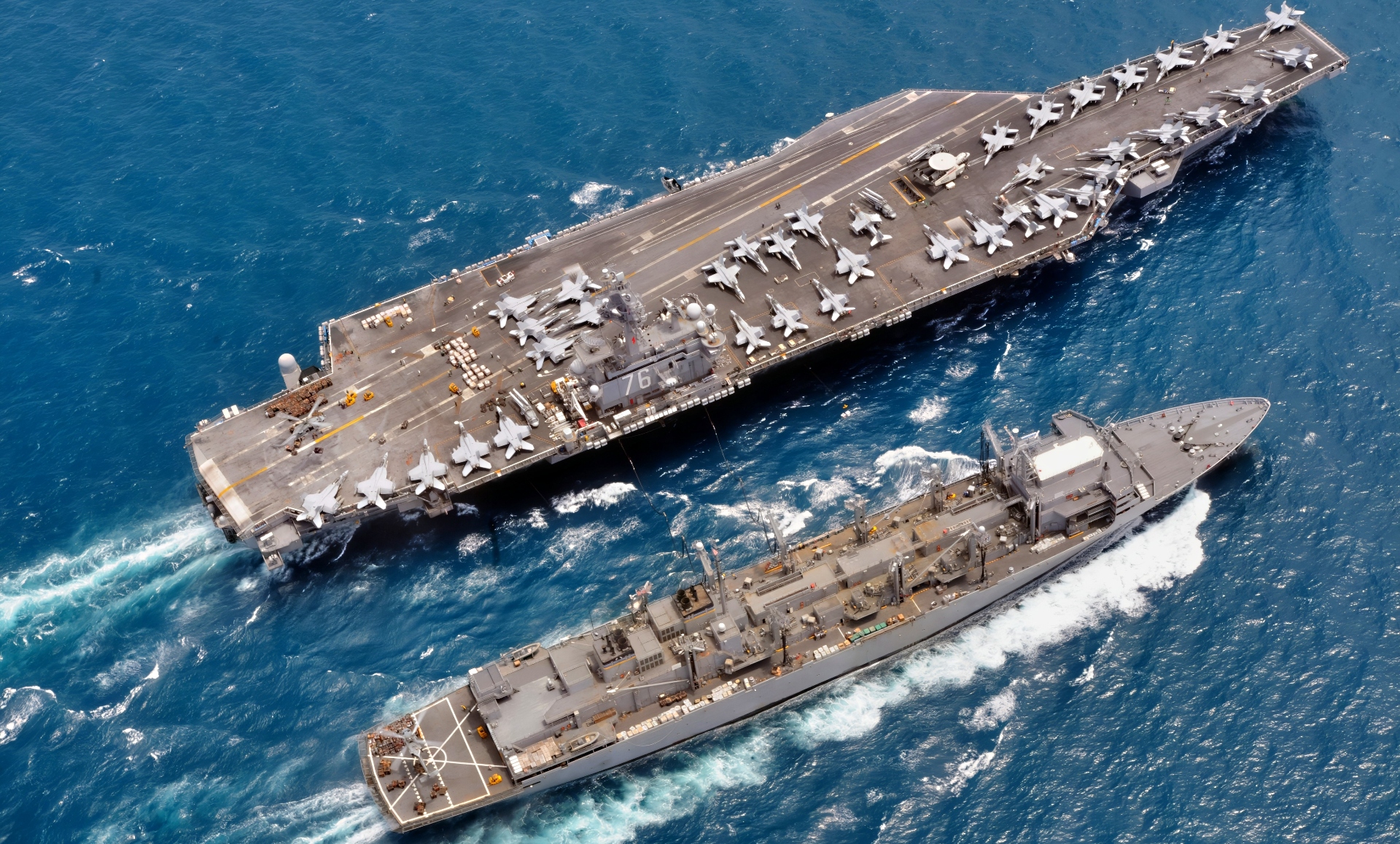 (August 15, 2008) With SH-60 helicopters moving pallets of supplies both USS Ronald Reagan (CVN 76) and USNS Bridge (T-AOE 10) work together during a replenishment at sea or RAS. With Reagan's six galleys and approximately 4,100 Sailors it takes a lot of produce to feed that many folks and the Nimitz-class aircraft carrier got what it needed from USNS Bridge to do so. The Ronald Reagan Carrier Strike Group is on a routine deployment in the 7th Fleet area of responsibility. Operating in the Western Pacific and Indian Ocean, the U.S. 7th Fleet is the largest of the forward-deployed U.S. fleets covering 52 million square miles, with approximately 50 ships, 120 aircraft and 20,000 Sailors and Marines assigned at any given time. U.S. Navy photo by Senior Chief Mass Communication Specialist (SW/NAC) Spike Call