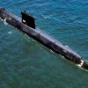 An aerial port quarter view of the nuclear-powered attack submarine ex-USS NAUTILUS (SSN 571). The NAUTILUS was being towed to Groton, Connecticut, where it became a museum.