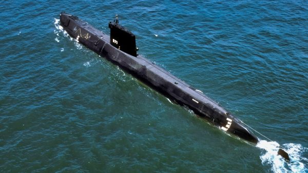 An aerial port quarter view of the nuclear-powered attack submarine ex-USS NAUTILUS (SSN 571). The NAUTILUS was being towed to Groton, Connecticut, where it became a museum.