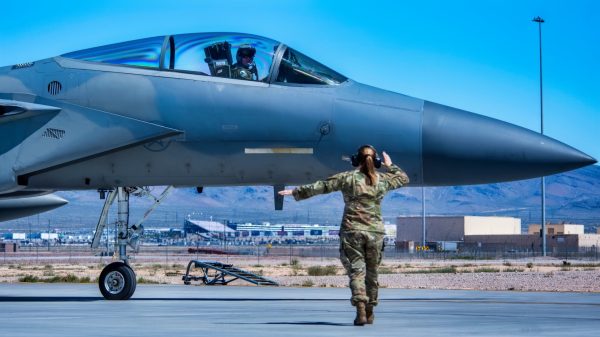 U.S. Air Force Senior Airman Marydith Stidham, a 125th Aircraft Maintenance Squadron crew chief, marshals Capt. Steven Fleming, a 125th Fighter Squadron F-15C Eagle pilot, while taxiing on the flightline at Nellis Air Force Base, Nevada, April 16, 2024. Units assigned to the 125th Fighter Wing participated a two-week exercise in support of the USAF Weapons School. During the exercise, the wing operated in both daytime and nighttime vulnerability periods in a contested degraded environment, preparing students for real-world conditions. (U.S. Air Force photo by Senior Airman Jose Miguel T. Tamondong)