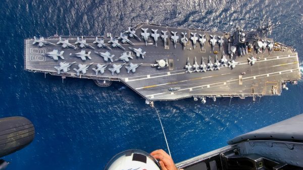 Explosive Ordnance Disposal 1st Class Christopher Courtney assigned to Explosive Ordnance Disposal Mobile Unit Six (EODMU-6), Det. 16 assist his team members during Special Purpose Insertion Extraction (SPIE) training from an SH-60 Seahawk helicopter. The Nimitz-class aircraft carrier USS Dwight D. Eisenhower (CVN-69) is deployed in support of Maritime Security Operations (MSO) and the global war on terrorism.