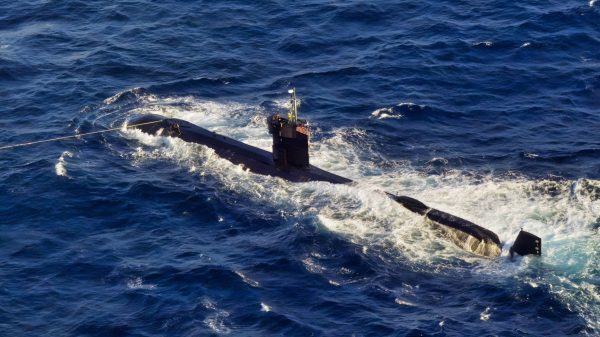 (May 22, 2002) -- With a two line attached to a tugboat for stability, USS DOLPHIN (AGSS 555) wallows in heavy seas after being abondoned by her crew following a fire and flooding. DOLPHIN was conducting routine operations near San Diego when the incident occurred.