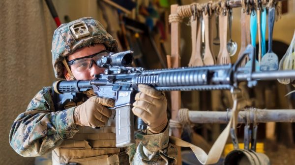 A U.S. Marine with Combat Logistics Battalion 2, Combat Logistics Regiment 2, 2nd Marine Logistics Group, posts security at the Infantry Immersion Trainer at Marine Corps Base Camp Lejeune, North Carolina, Nov. 21, 2025. The IIT is a facility which provides an urban training environment for Marines and Sailors, aiding in increasing combat efficiency by training in realistic conditions. (U.S. Marine Corps photo by Lance Cpl. Isabella Ramos)